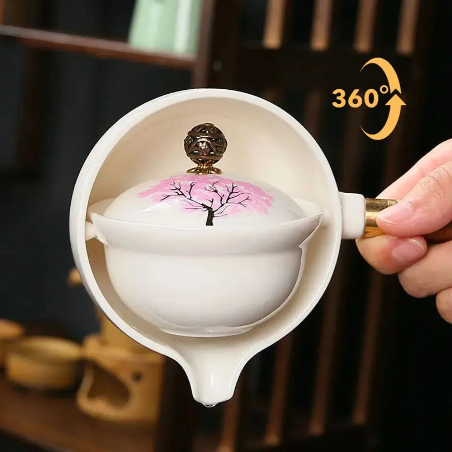 Ceramic teapot with cherry blossom decoration and rotating strainer