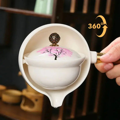 Ceramic teapot with cherry blossom decoration and rotating strainer