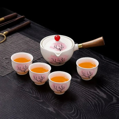 Ceramic teapot with cherry blossom decoration and rotating strainer